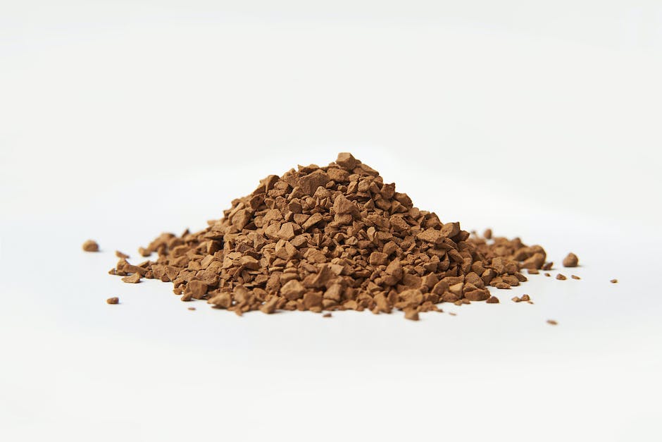 Close-up of coffee grounds spilled on soil, ready to be used as a soil amendment