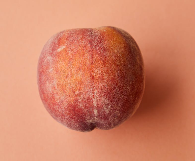 A close-up image of a peach pit with dashes instead of spaces