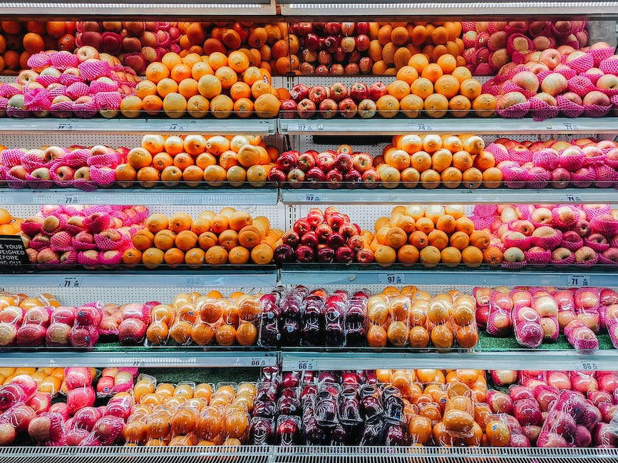 Image description: Freshly picked pink apples arranged in a bowl with leaves on top