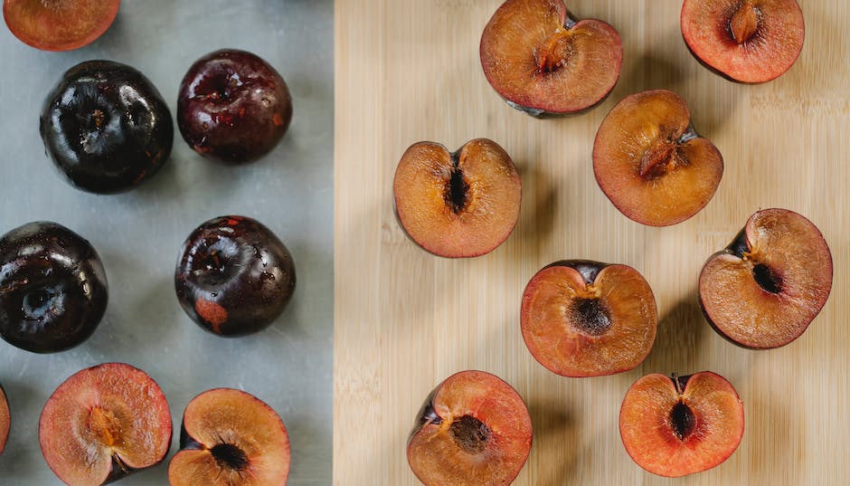 A ripe plum on a tree branch.