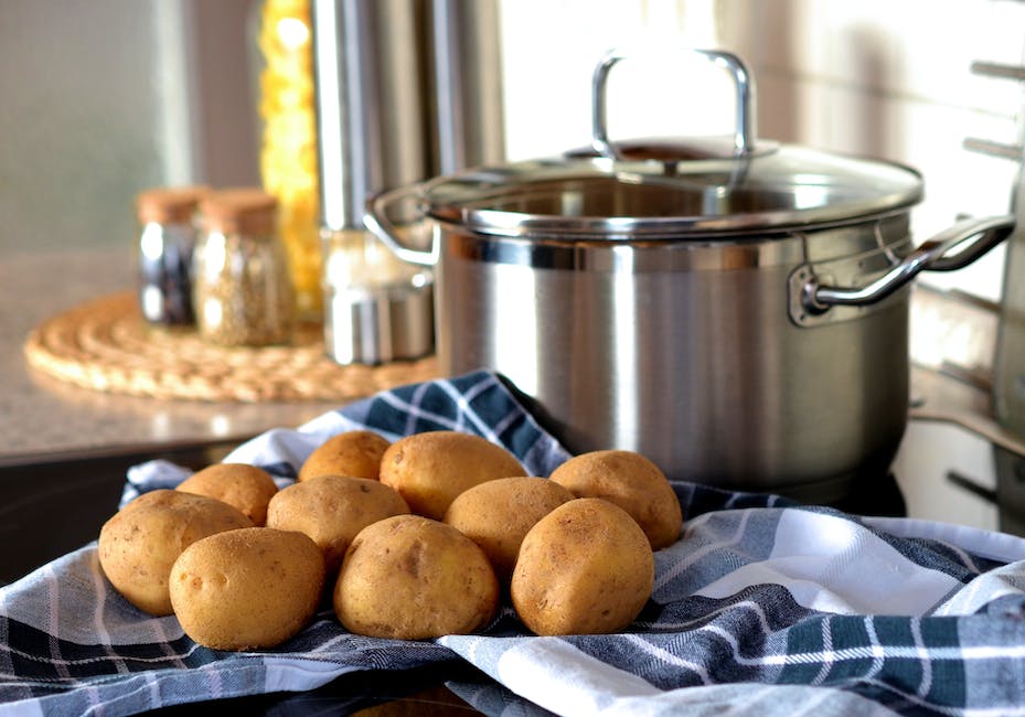 A close-up image of various potatoes, showing their different colors and sizes