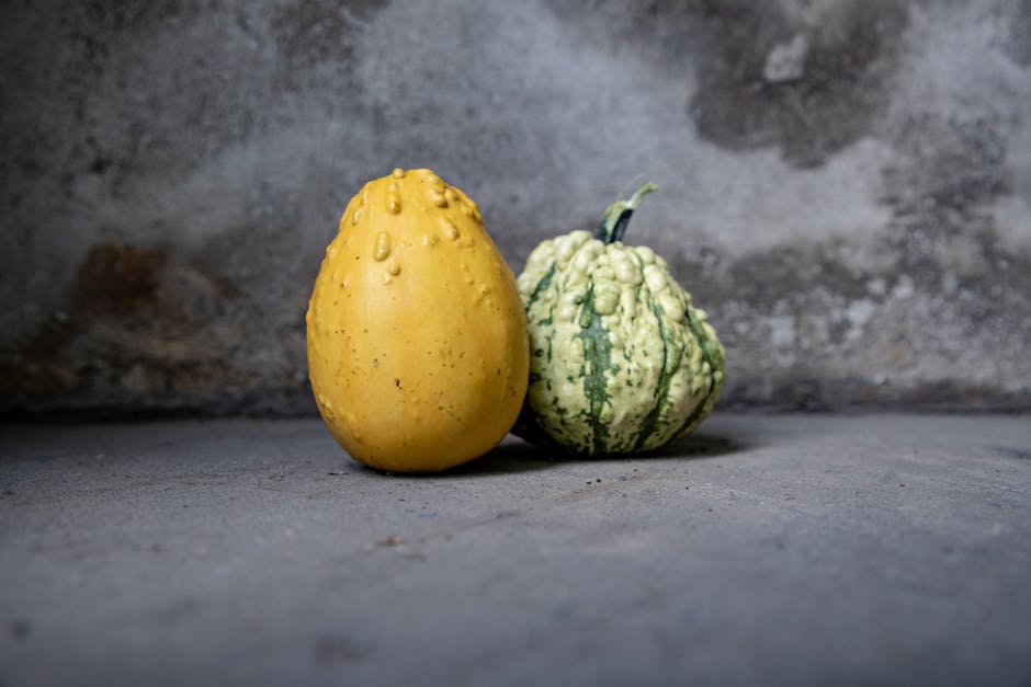 Image of a perfectly ripe spaghetti squash surrounded by other fruits and vegetables.